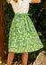 Woman wearing ModCloth The Garden Stroll Skirt in Hide & Squeak, a cotton voile A-line midi skirt with a whimsical mouse and wildflower print and removable tie belt.