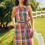 Front view of a colorful plaid button-front shirt dress with a removable sash belt.