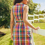 Back view of a sleeveless cotton plaid dress with a pointed collar and tailored silhouette.