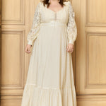 A plus-size model wearing a high collar corselette maxi dress in beige, featuring long sleeves with lace detailing and a ruffled hem.