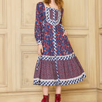 A model wearing a GUNNE SAX for ModCloth Veronica Midi Dress with a floral pattern and long sleeves, paired with red boots.