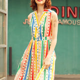 Front view of the Rainbow Carousel fit-and-flare dress featuring rainbow stripes, polka dots, and a button-front design.