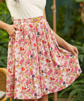 High-waisted A-line skirt with dragon fruit print and matching belt, front view