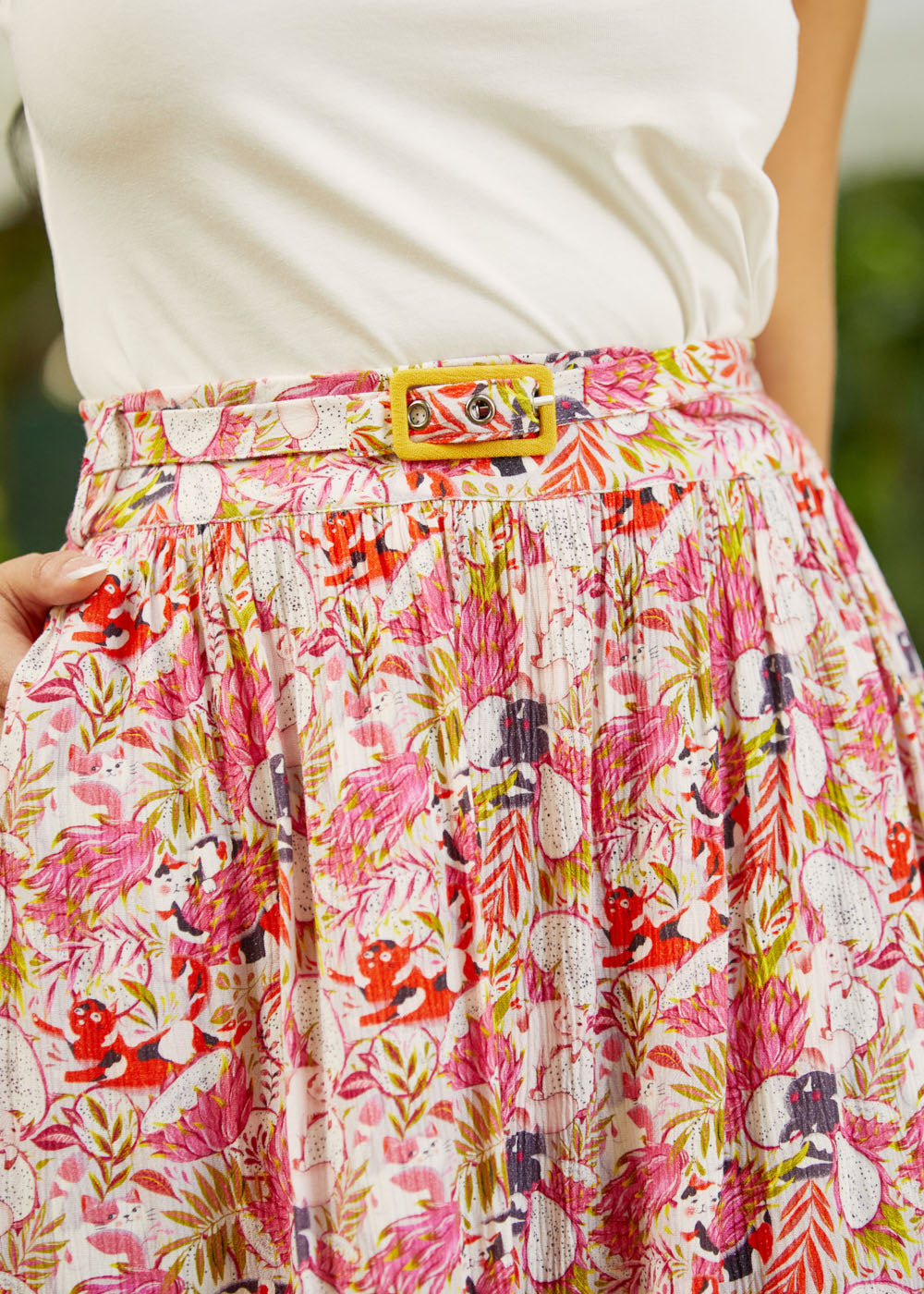 Close-up of waist detailing with coordinating belt and buckle closure