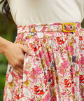 Close-up of dragon fruit print skirt revealing hidden cat motifs within the pattern