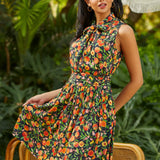 Model wearing peach print bow neck fit and flare dress with sleeveless silhouette