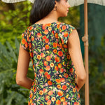 Back view of peach print blouse with relaxed fit and short sleeves