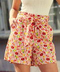Person wearing shorts with a lobster, lemon, and striped print on cotton fabric 