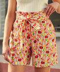 woman wearing vintage style paper bag waist shorts with novelty print