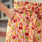 Close-up of elastic waist and bow tie detail on printed cotton shorts