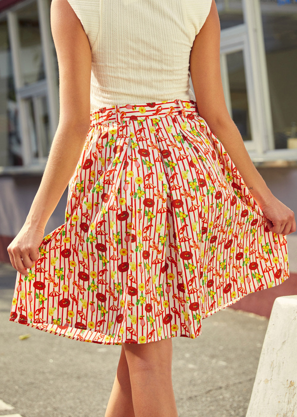Back view of pleated cotton skirt with elastic waistband and full silhouette