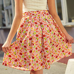 Back view of pleated cotton skirt with elastic waistband and full silhouette