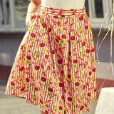 pleated skirt on woman, fabric with lobster, citrus, and striped print