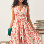 Woman wearing a floral dress with seahorse print, holding books in a library setting