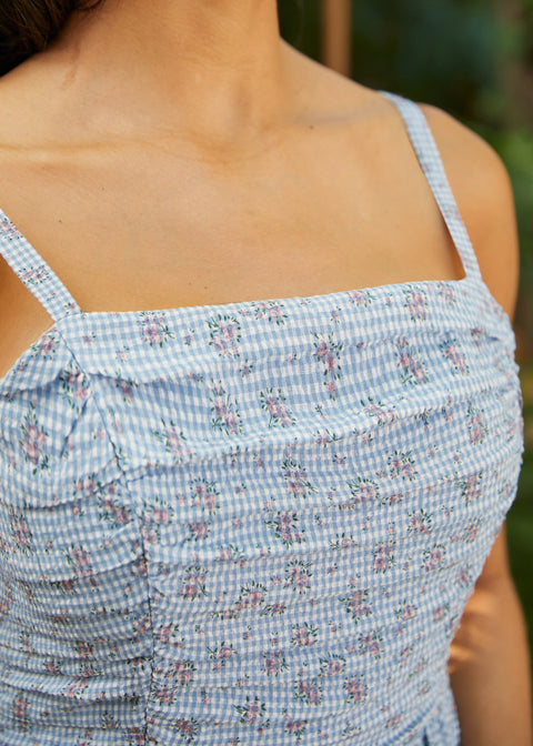 Close-up of ruched bodice on floral gingham sundress with adjustable straps and textured detailing