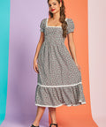 Full-length view of black and white gingham strawberry midi dress with lace trim