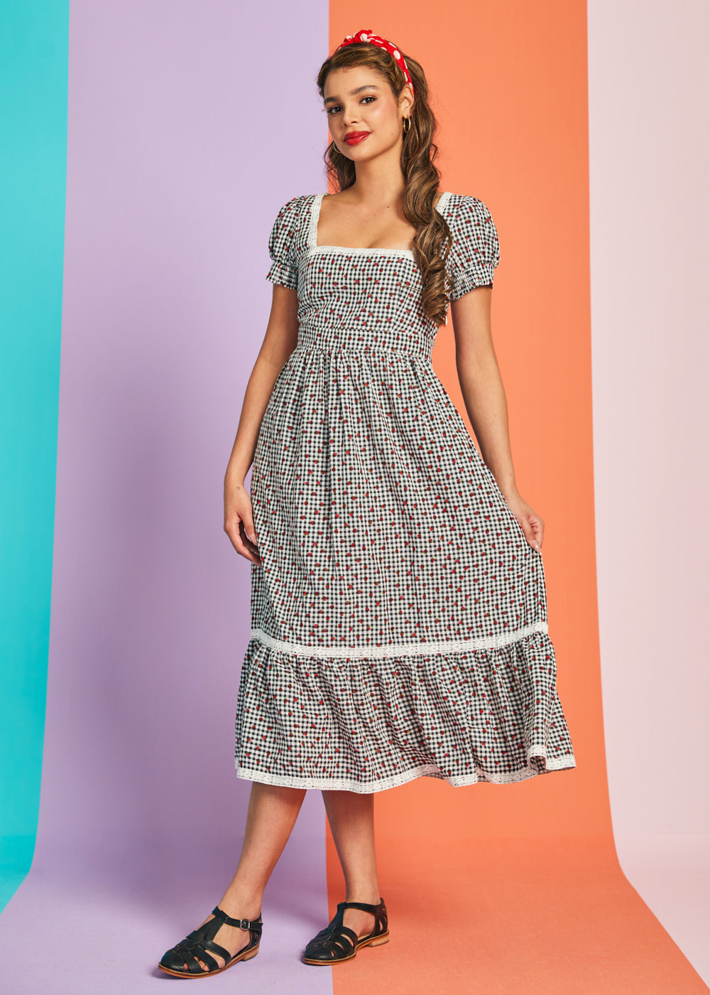 Full-length view of black and white gingham strawberry midi dress with lace trim