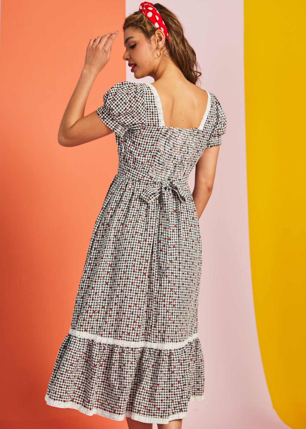 Back view of gingham midi dress with smocked back and waist tie detail