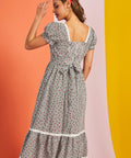 Back view of gingham midi dress with smocked back and waist tie detail