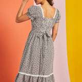 Back view of gingham midi dress with smocked back and waist tie detail