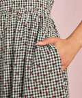 Close-up of strawberry gingham cotton fabric and side pocket detail