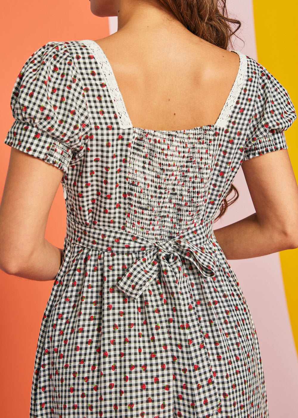 Close-up of lace-trimmed square neckline on strawberry gingham midi dress
