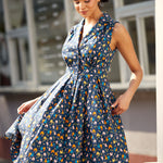 Woman twirling in a sleeveless fit-and-flare dress with playful chicken print.