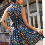 Back view of a farmyard chicken print dress with self-tie sash and novelty farmyard print.