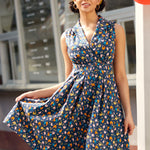 Woman wearing vintage-inspired chicken print cotton dress with pockets and retro-inspired styling.