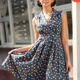 Woman wearing vintage-inspired chicken print cotton dress with pockets and retro-inspired styling.
