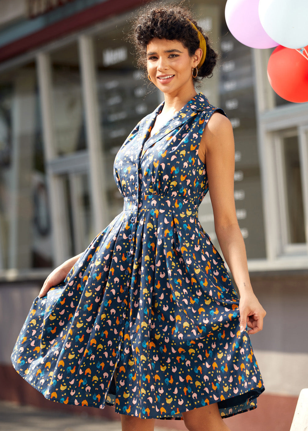 Side view of a vintage inspired chicken print dress showing the flattering silhouette and full skirt.
