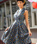 Side view of a vintage inspired chicken print dress showing the flattering silhouette and full skirt.