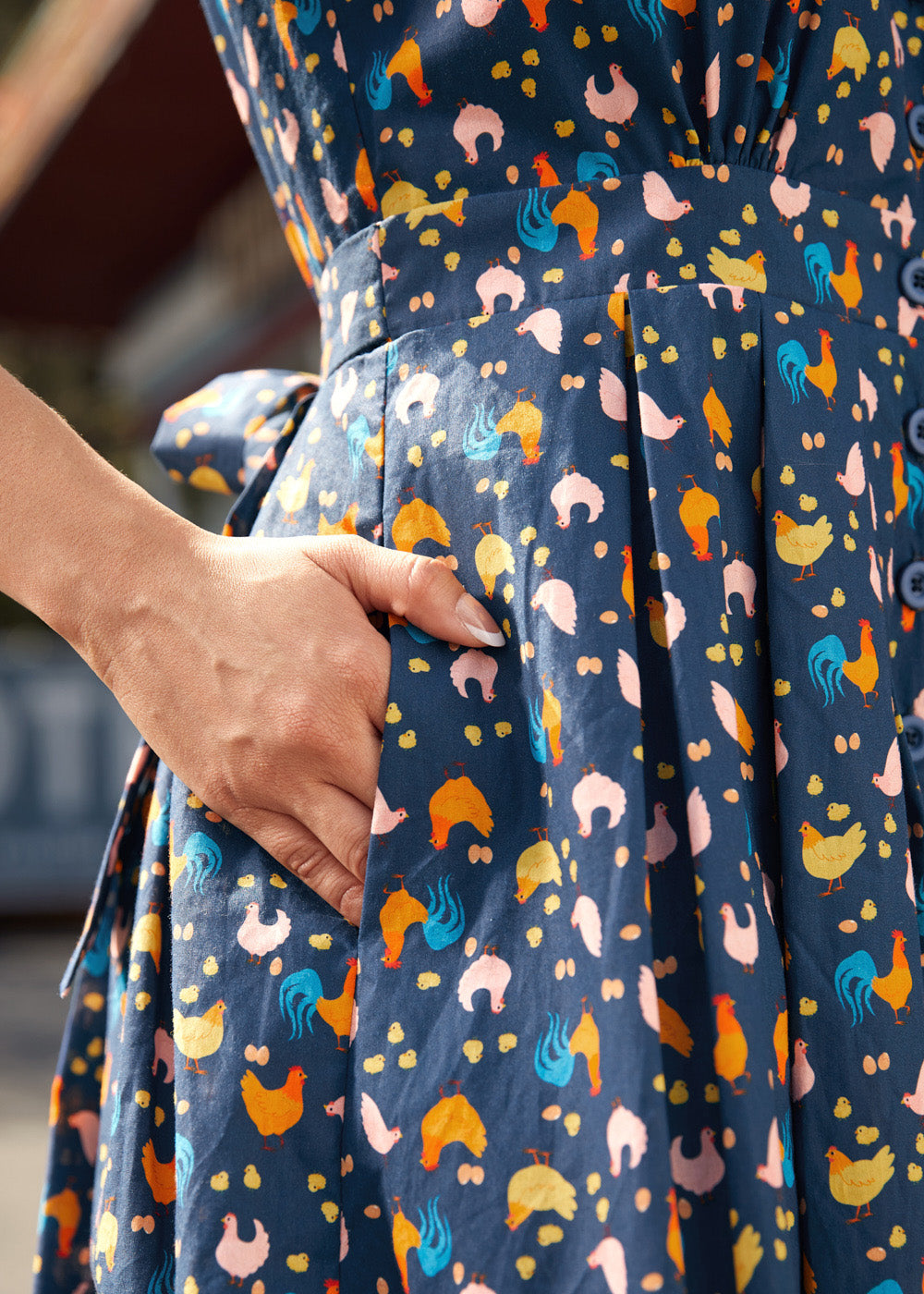 Close-up of side pocket on the Hen House Party novelty chicken print cotton dress.