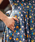 Close-up of side pocket on the Hen House Party novelty chicken print cotton dress.