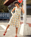 Vintage-inspired sleeveless midi dress with button-front, removable tie belt, and novelty vegetable print.
