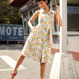 Vintage-inspired sleeveless midi dress with button-front, removable tie belt, and novelty vegetable print.