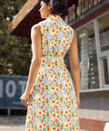 Back view of a sleeveless fit-and-flare cotton dress with collared neckline and vegetable print.