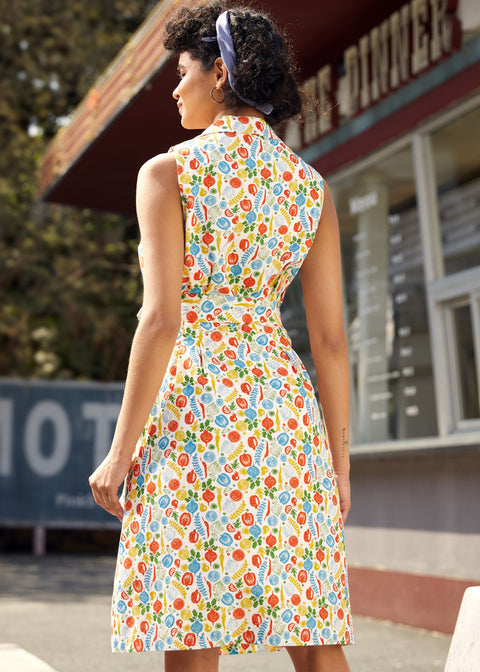 Back view of a sleeveless fit-and-flare cotton dress with collared neckline and vegetable print.