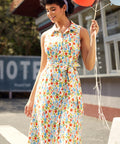 Woman wearing a vintage-inspired sleeveless cotton shirt dress with colorful vegetable print and pockets.