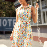 Woman wearing a vintage-inspired sleeveless cotton shirt dress with colorful vegetable print and pockets.