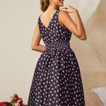 Back view showing smocked waistband and zipper detail on midi dress