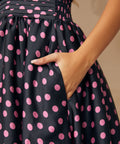 Model placing hand in side seam pocket of midi party dress