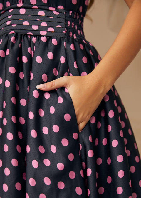 Model placing hand in side seam pocket of midi party dress