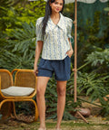 Woman styling the Dear Diary Blouse with navy shorts for a vintage-inspired spring and summer outfit.