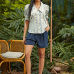 Woman styling the Dear Diary Blouse with navy shorts for a vintage-inspired spring and summer outfit.