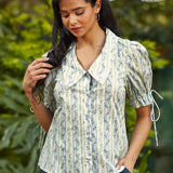 Front view of the Dear Diary Blouse in Blue Willow featuring a floral stripe print, oversized collar, and fabric-covered button front.