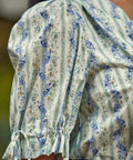 Detail of the adjustable tie cuff and softly gathered puff sleeve on the Dear Diary Blouse in Blue Willow.