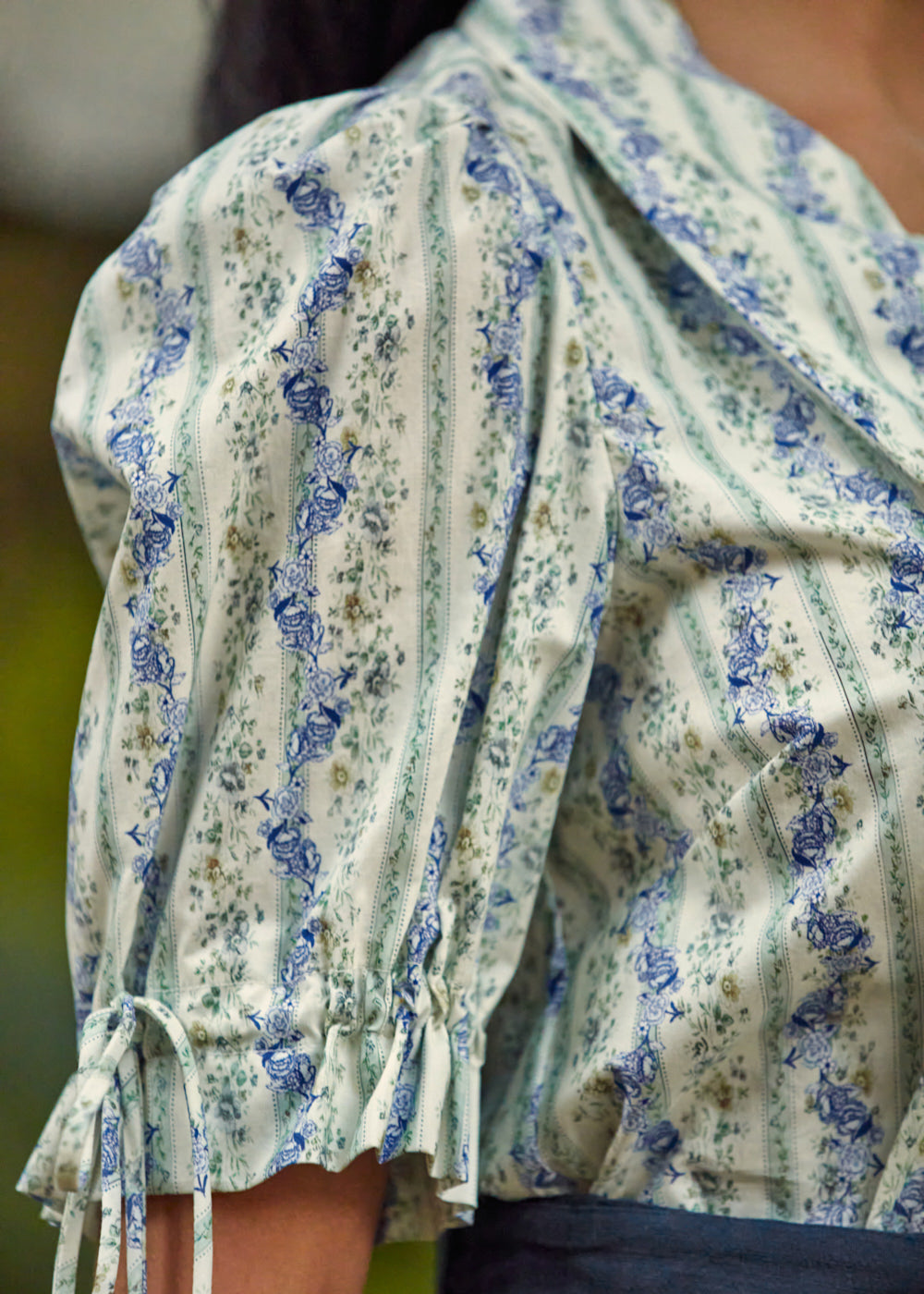 Detail of the adjustable tie cuff and softly gathered puff sleeve on the Dear Diary Blouse in Blue Willow.