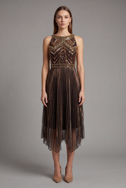 Woman wearing a gold flapper dress with intricate detailing on a gray background
