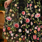 gored skirt detail on fit and flare party dress showing floral embroidery flowy a line shape and fabric movement